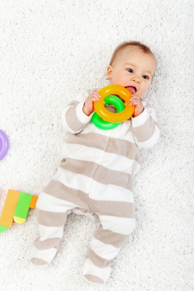 2659327-baby-girl-playing-on-the-floor-chewing-toys